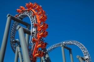 A rollercoaster doing a loop against a blue sky