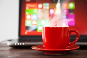 Laptop and a cup of coffee on a table
